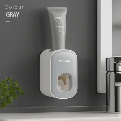 Wall-mounted magnetic inverted toothbrush holder with automatic toothpaste squeezer